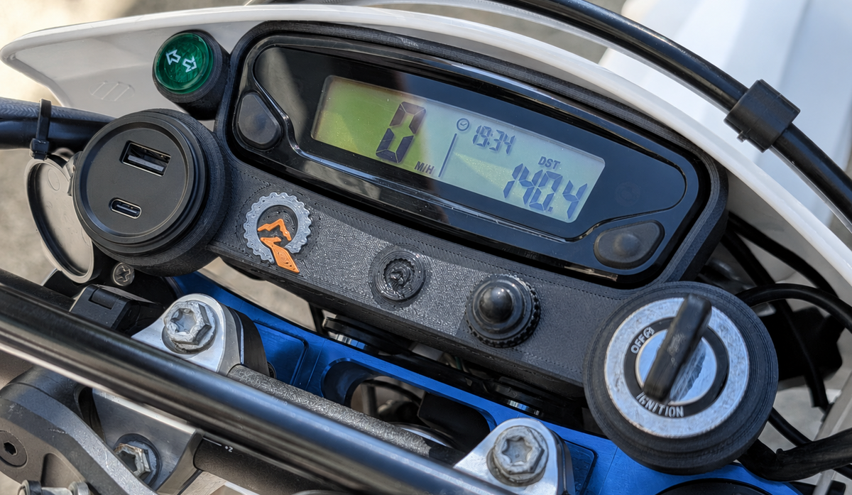 Quinnware dashboard installed on a Husqvarna FE/TE with speedometer, USB outlet, indicator light, and ignition switch